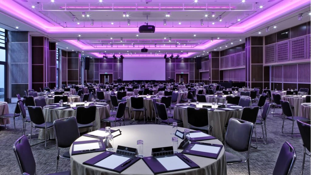 hotel booked for an event, purple decoration, chairs, tables, purple lights 