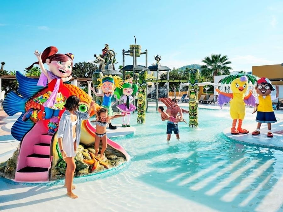 a family playing outside the hotel in a pool