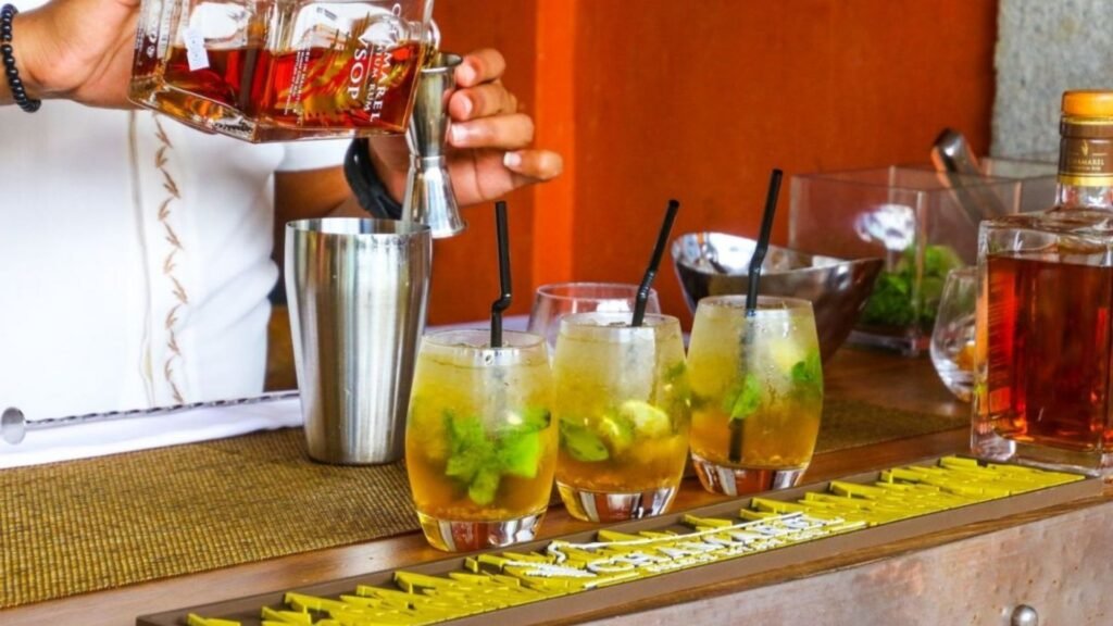 a man putting wine showing Sustainable Choices with Hotel Drinks